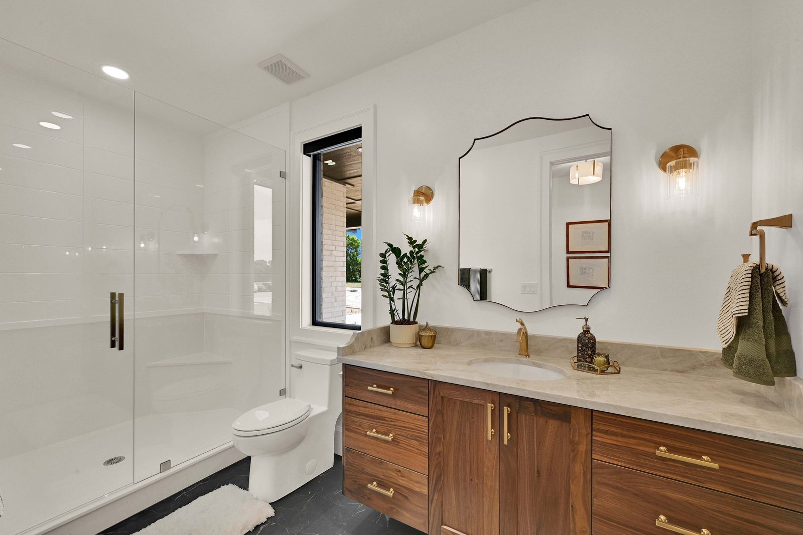 North of Creekside bathroom with walnut vanity and scalloped mirror, 2026 Top of Utah Parade of Homes