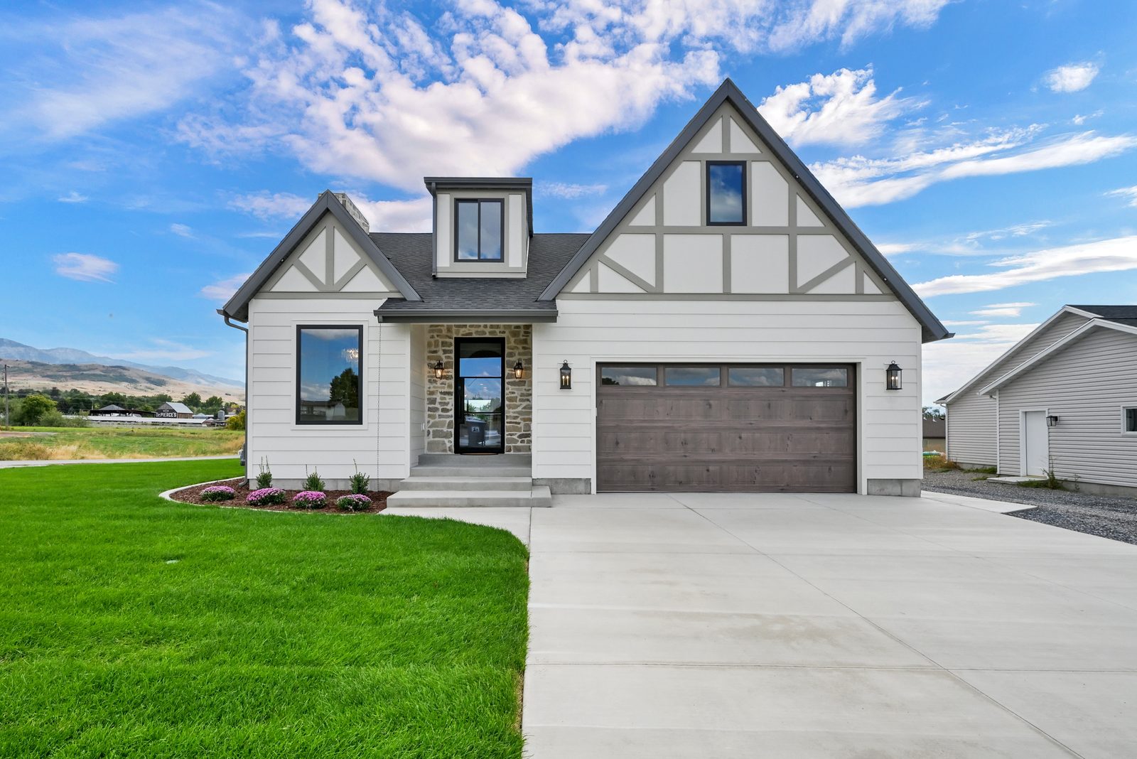 The Lucy front exterior with Tudor-inspired gables and stone entry, 2025 Top of Utah Parade of Homes