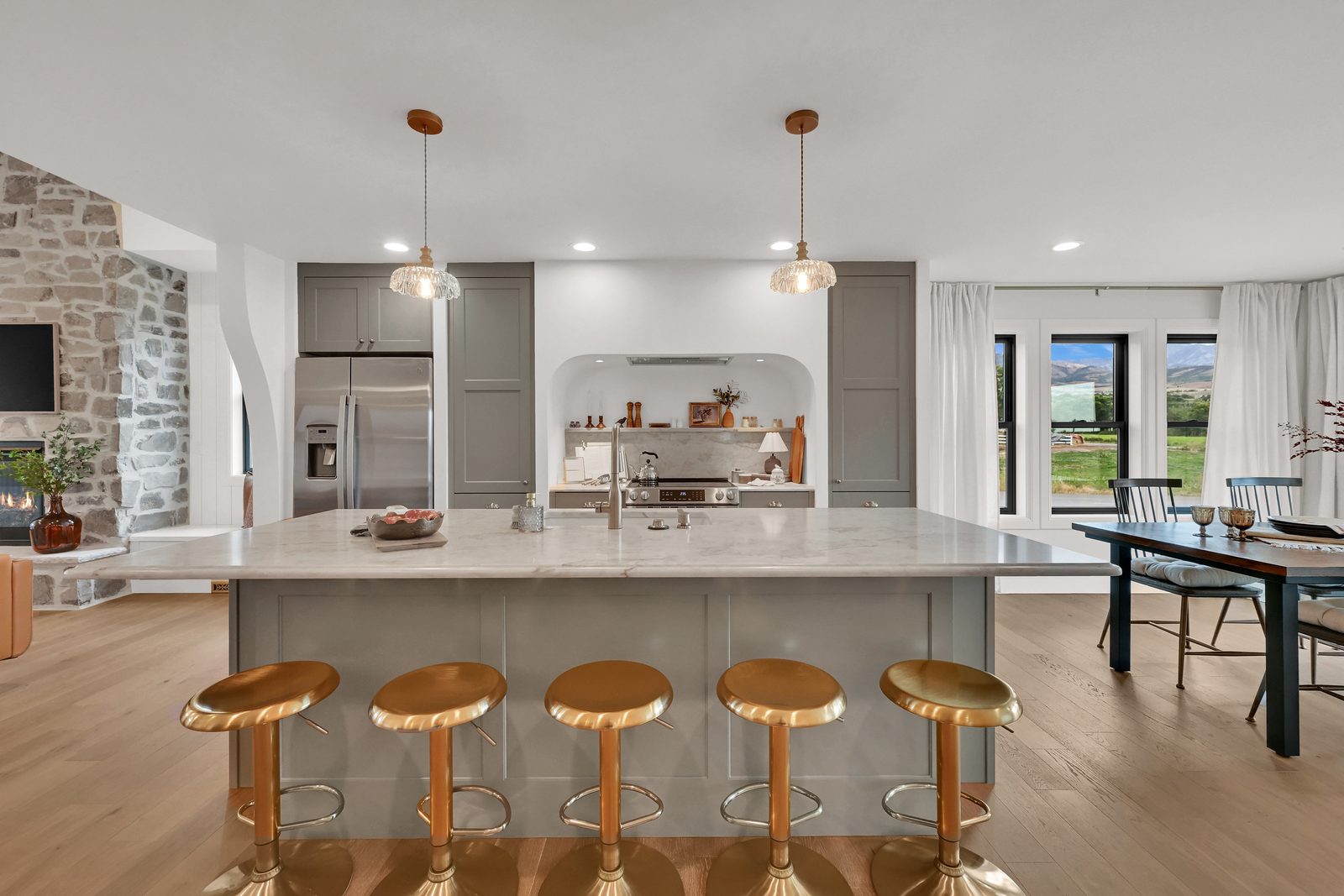 The Lucy kitchen with central island and arched range alcove, 2025 Top of Utah Parade of Homes
